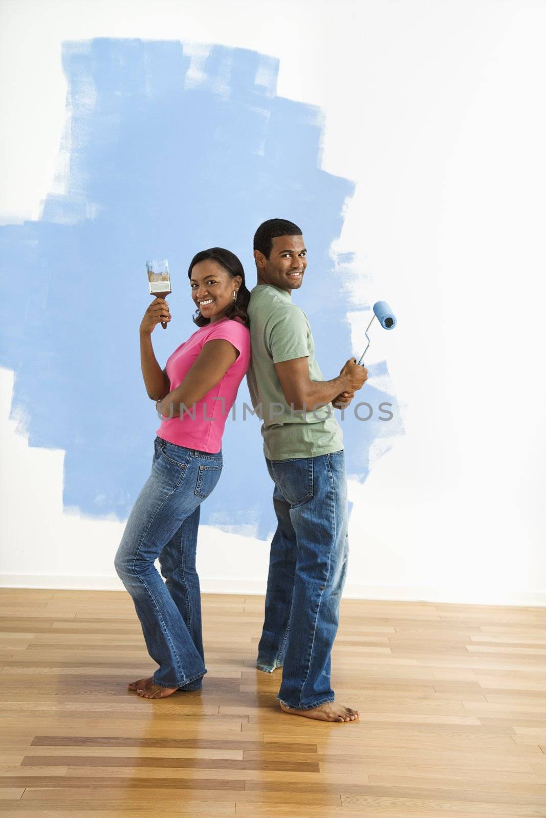 Couple portrait with paint supplies. by iofoto