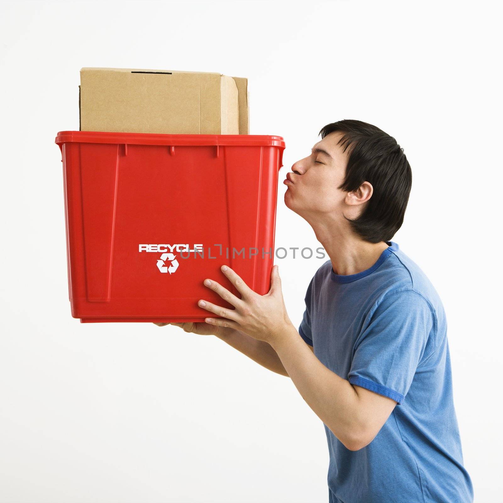 Man kissing recycling bin. by iofoto