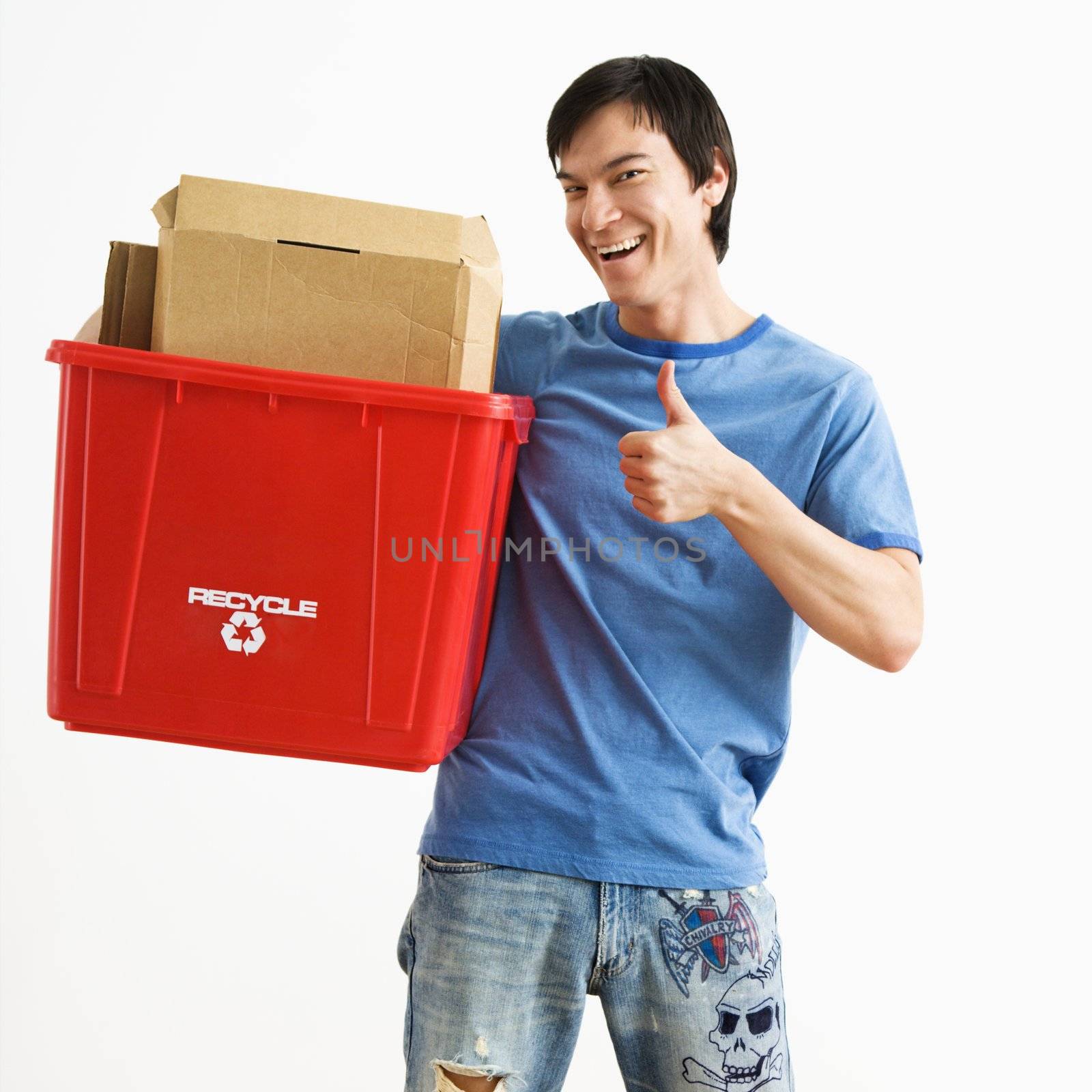 Man holding recycling bin. by iofoto