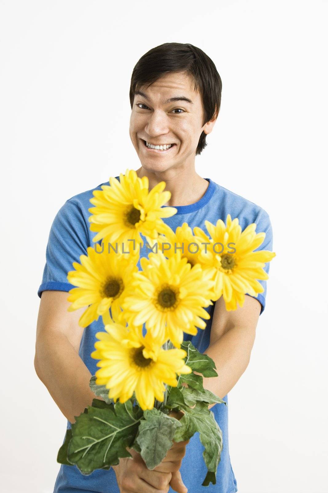 Smiling man holding bouquet. by iofoto