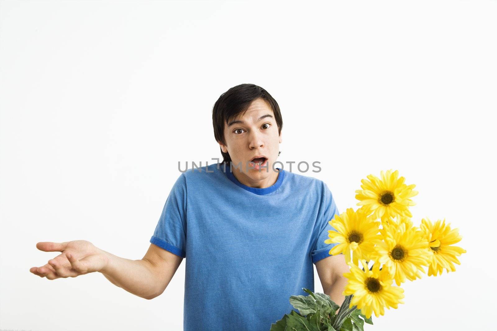 Shrugging man holding bouquet. by iofoto