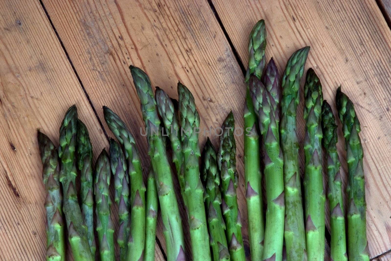 Asparagus heads on a bench in the garden