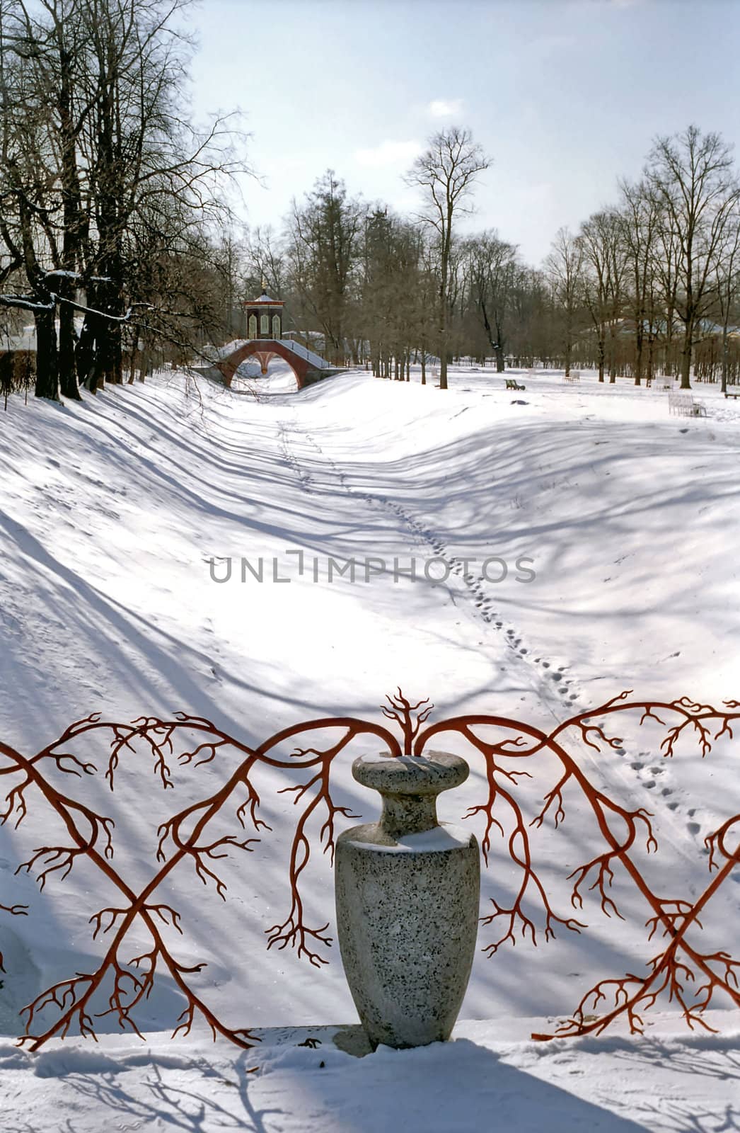 Decoration of stone vase with red branches on snow background