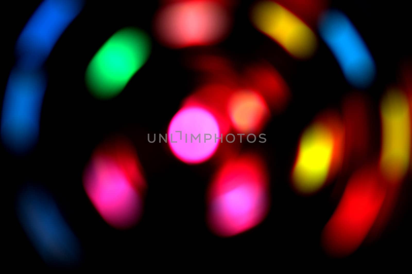 Colorful blurred lights on a dark background.  Used a spin effect.