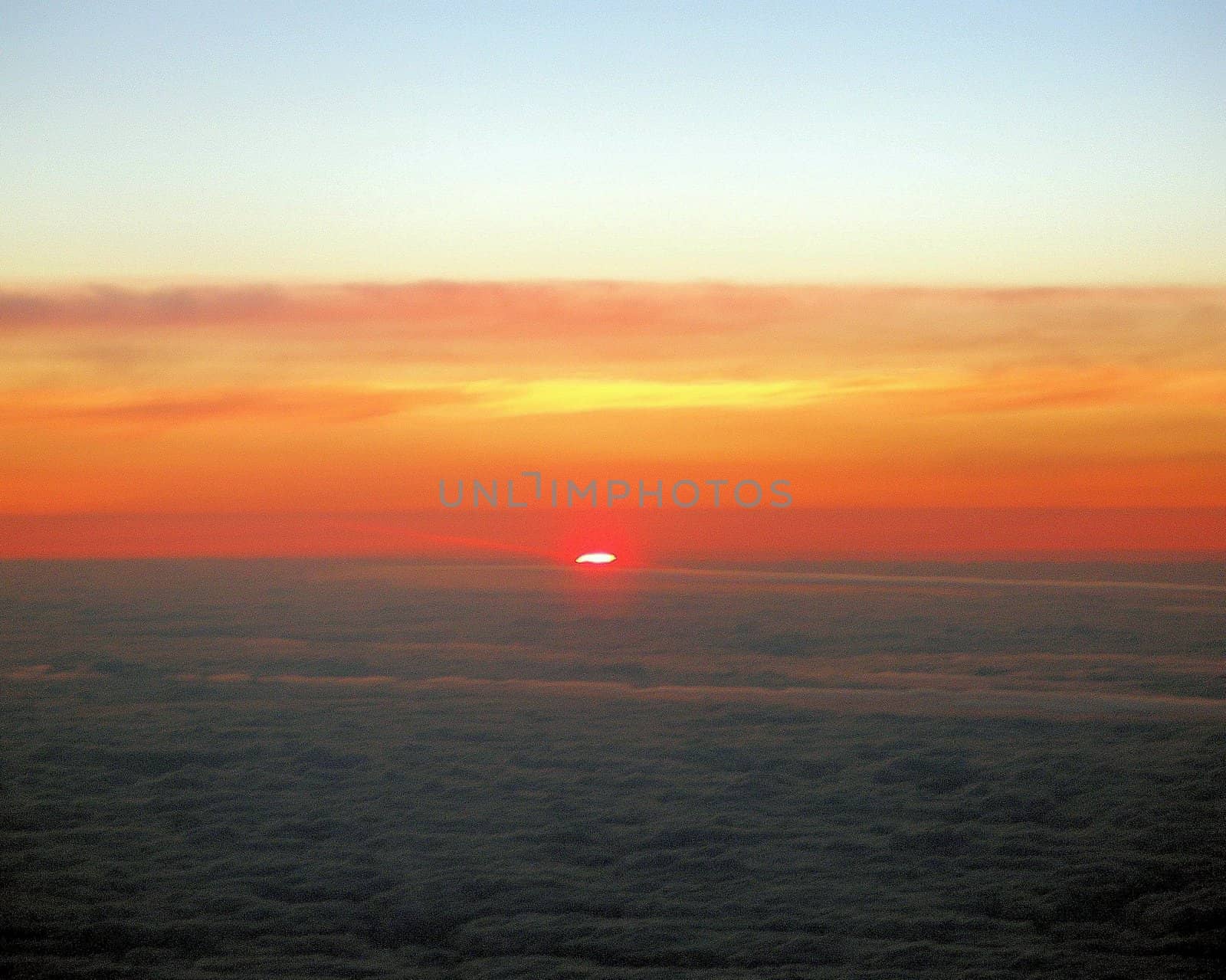 The view from an aeroplane of the sunset.