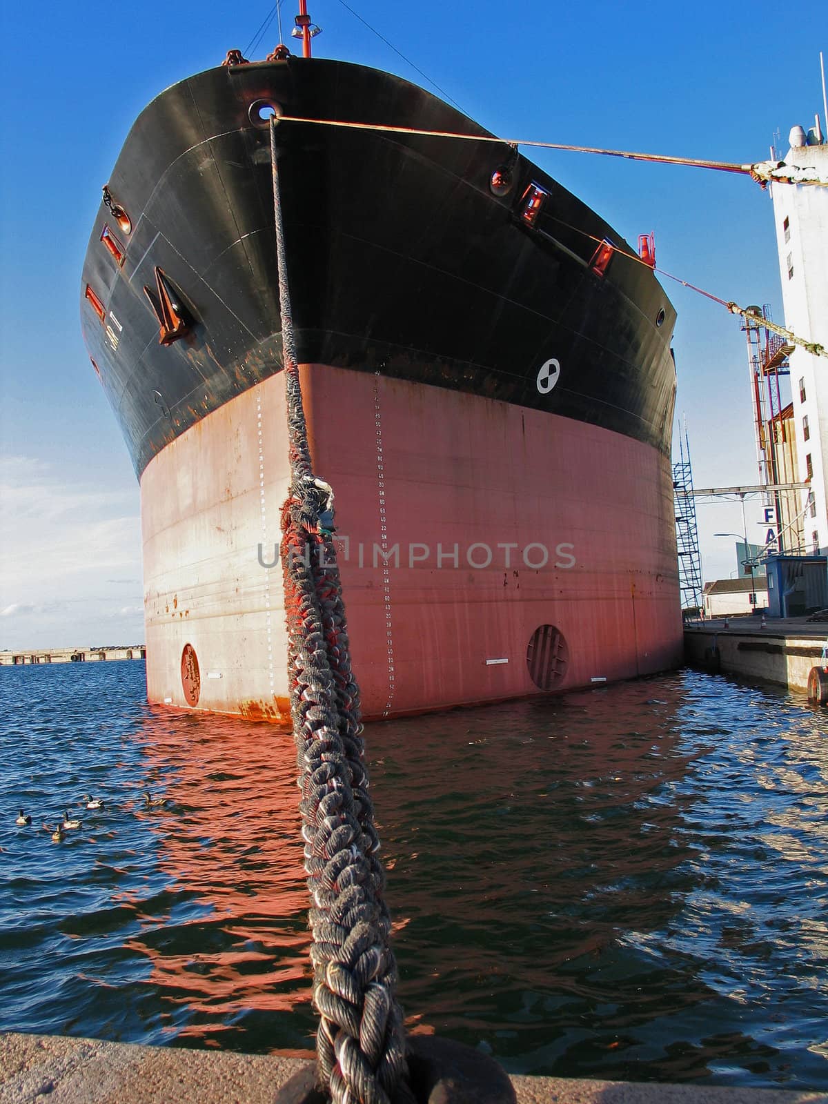 Commercial Cargo boat moored to a dock in a port