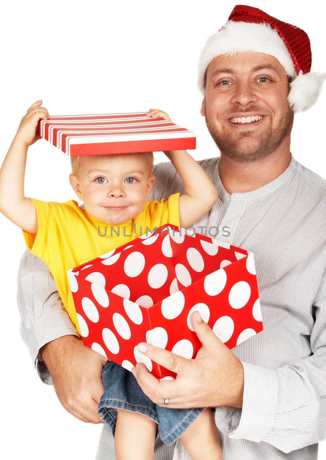 Baby boy with his father for Christmas holding a large gift box