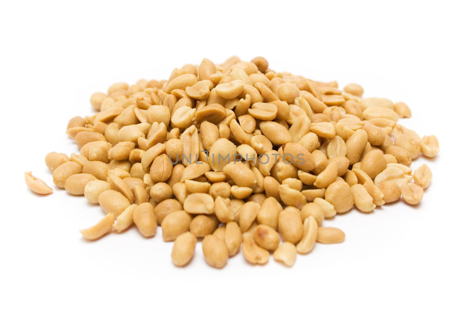 Peeled and salted peanuts isolated on a white background.