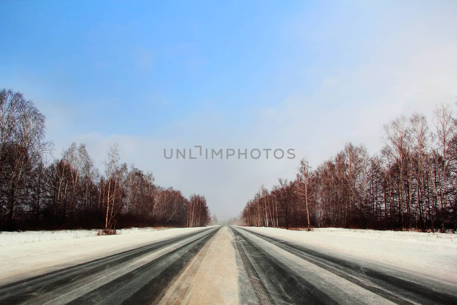 Image of winter road and cloudy sky