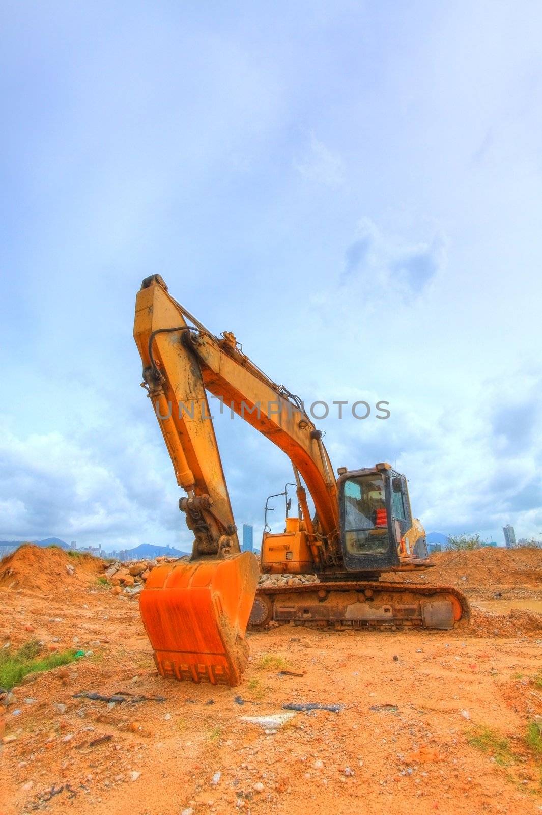 Yellow excavator on a hill 