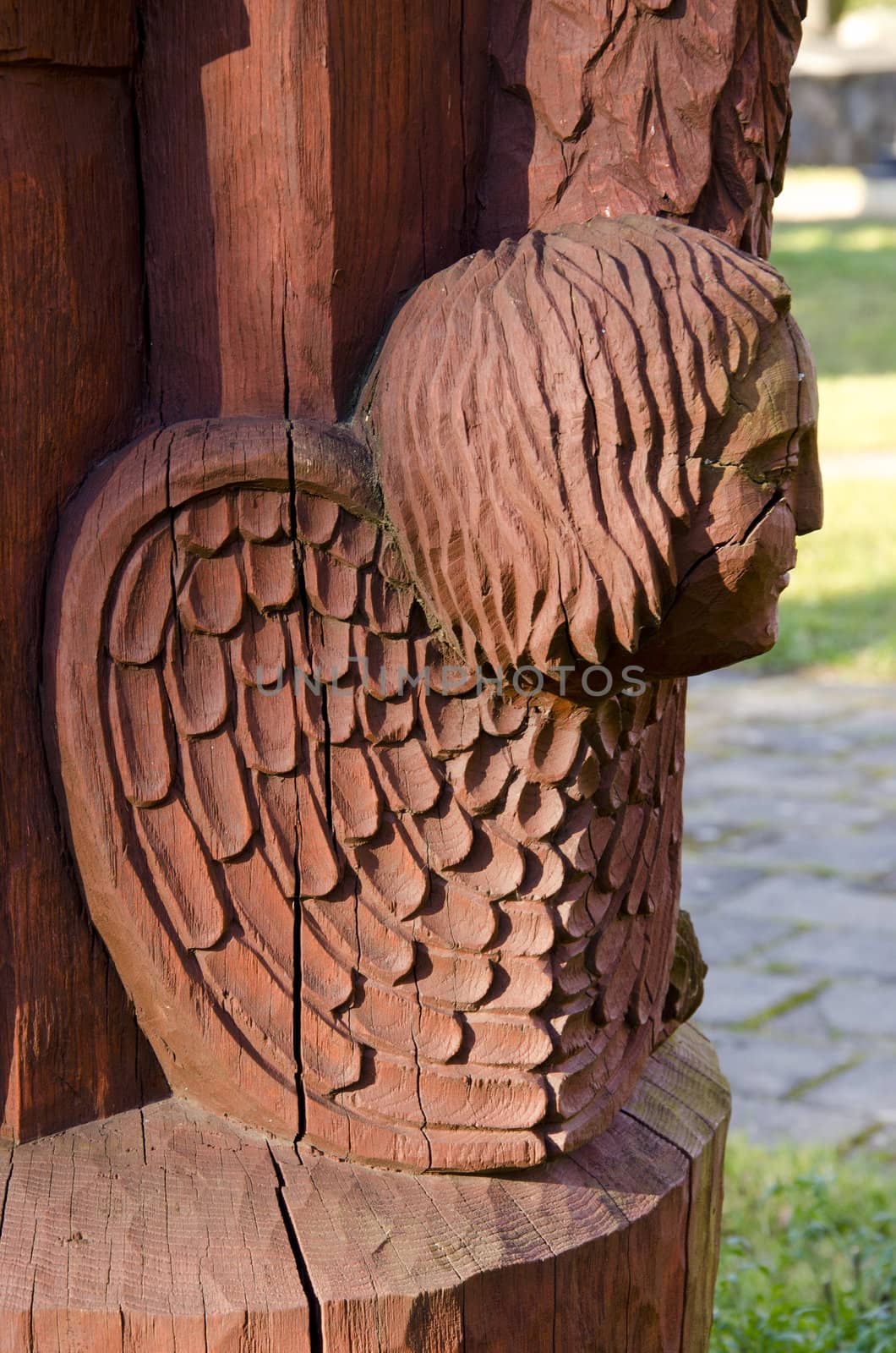 Cracks in wooden sculpture closeup. Fissionable head concept.