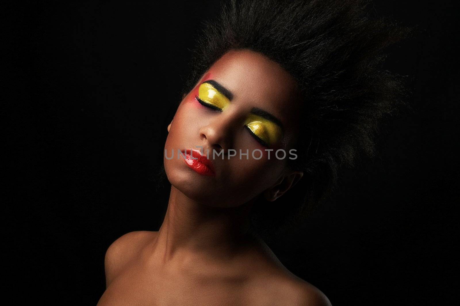 Beautiful black woman with glossy makeup isolated over black background