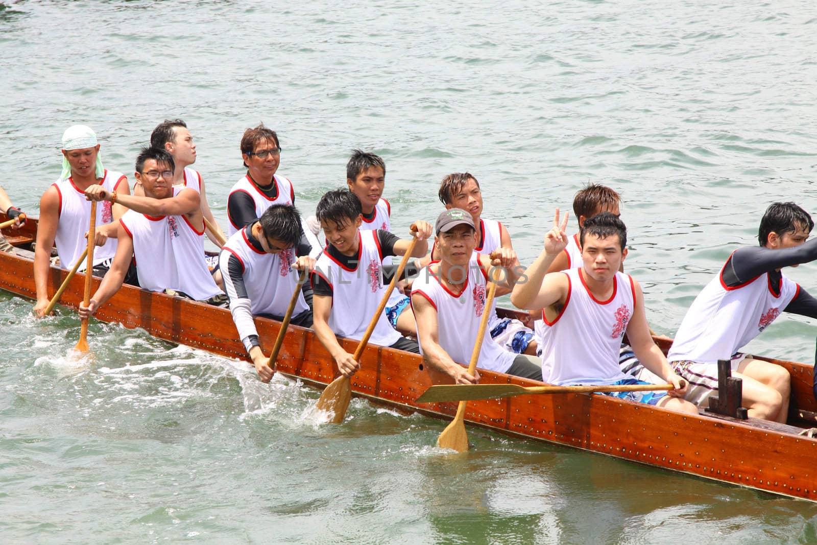 HONG KONG - JUN 6: Athletes fight hard for victory and they won at the dragon boat racing in Tuen Ng Festival 6, June 2011 in Tuen Mun, Hong Kong.