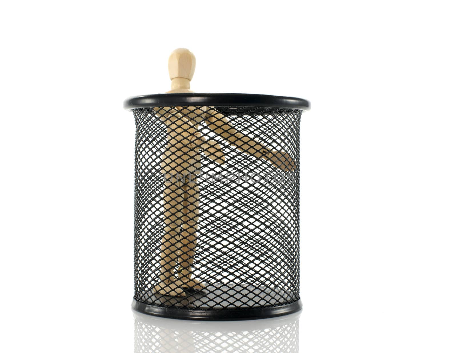 wooden puppet standing in black metal bin