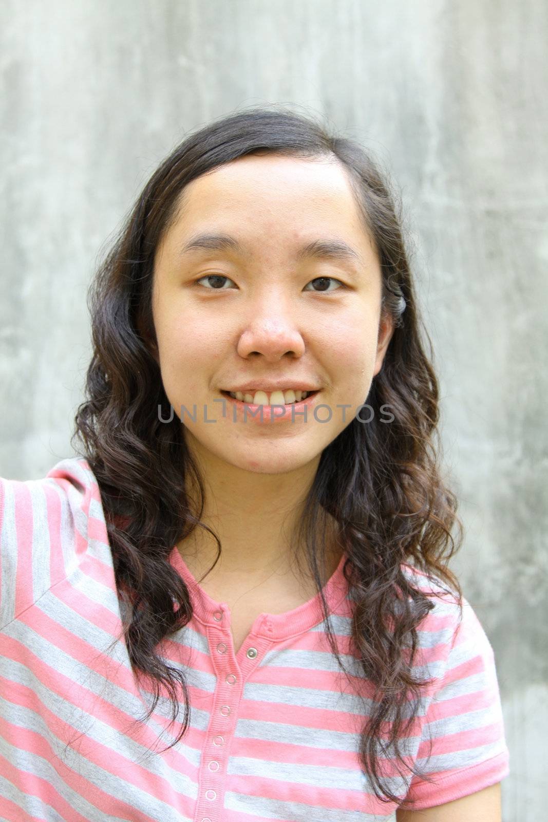 Portrait of young Asian woman outdoors. Shallow DOF.