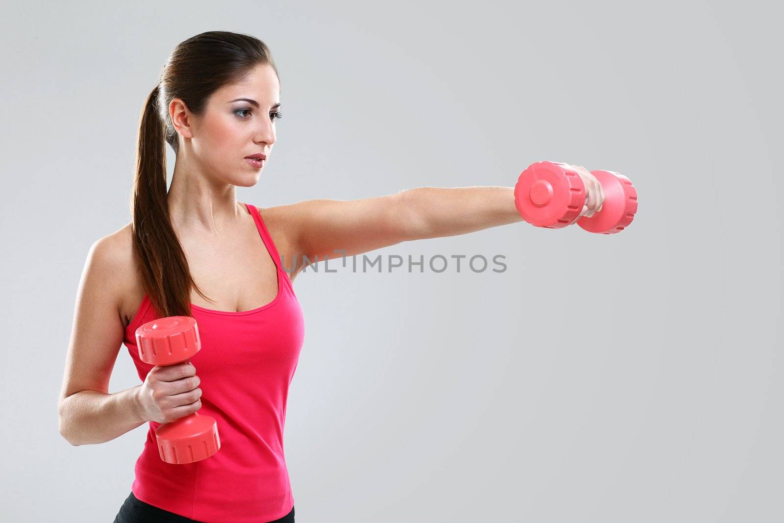 Young beautiful woman with dumbbells by rufatjumali