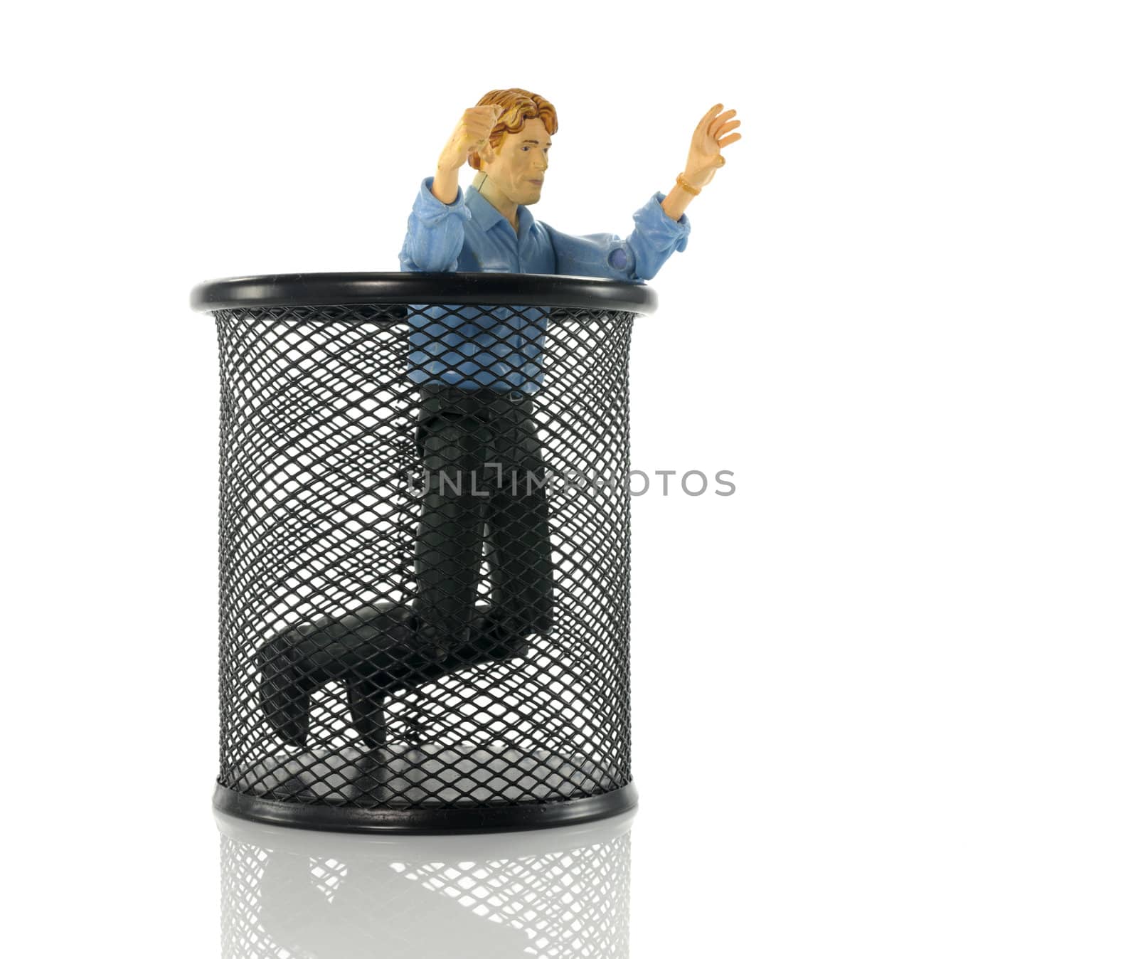 man puppet on his knees in black metal bin