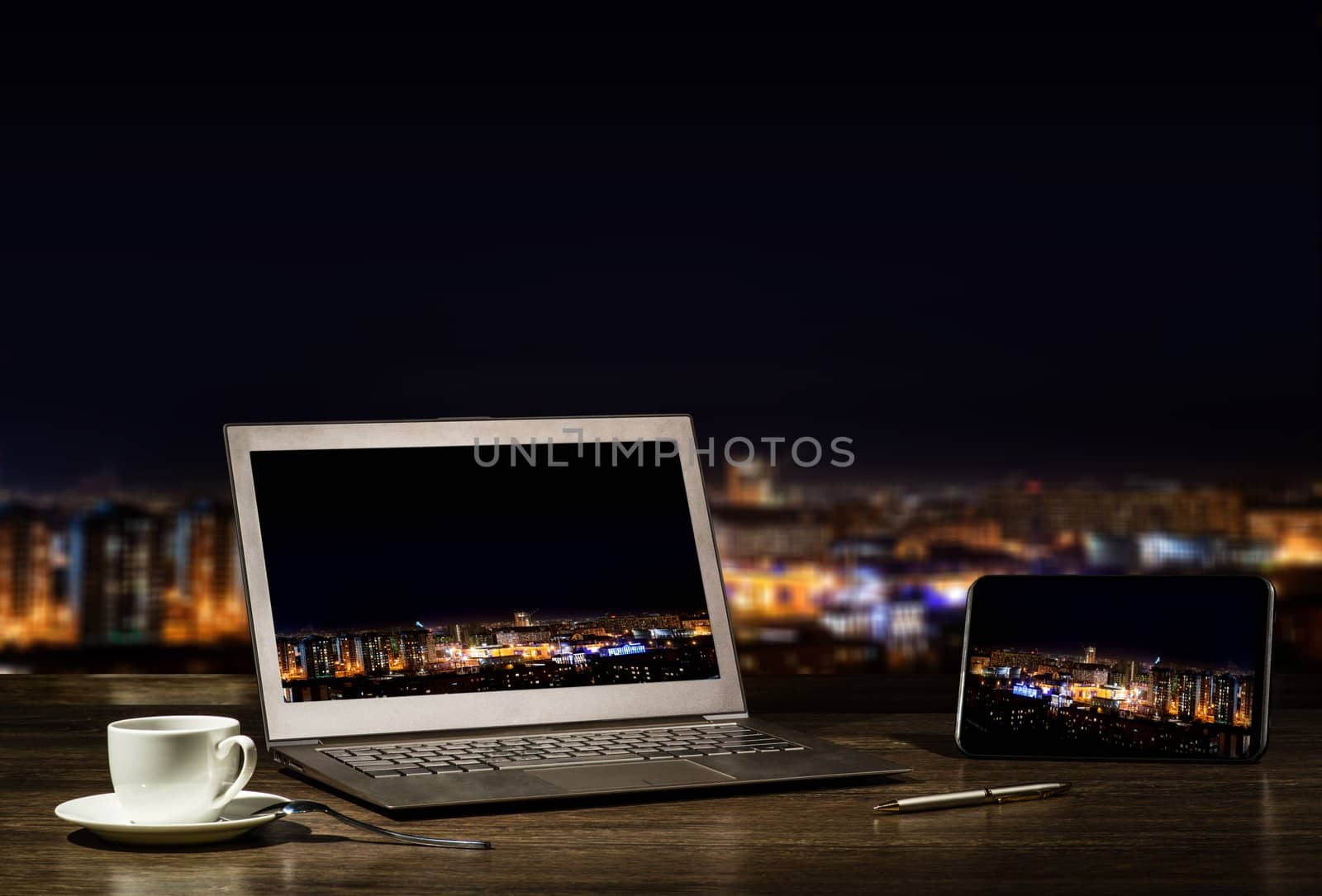 laptop and tablet, workplace businessman in the night city