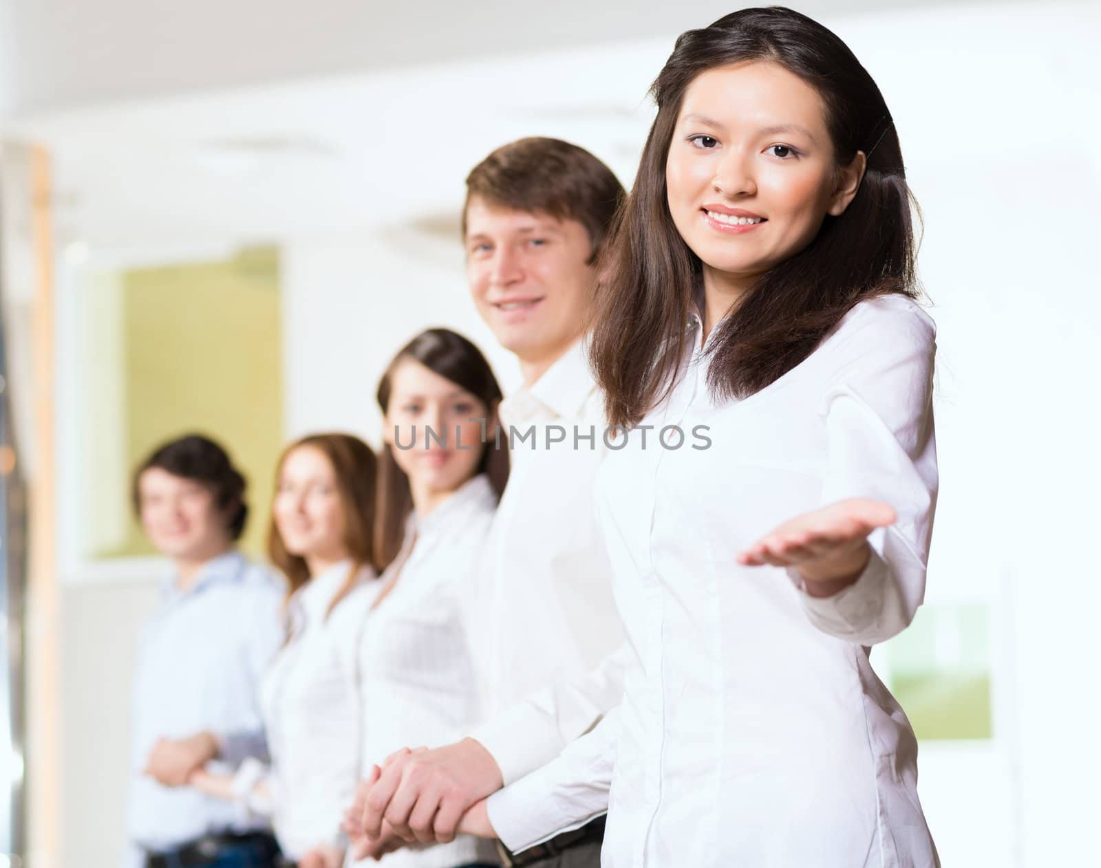 group of people holding hands, woman holds out her hand, the concept of teamwork