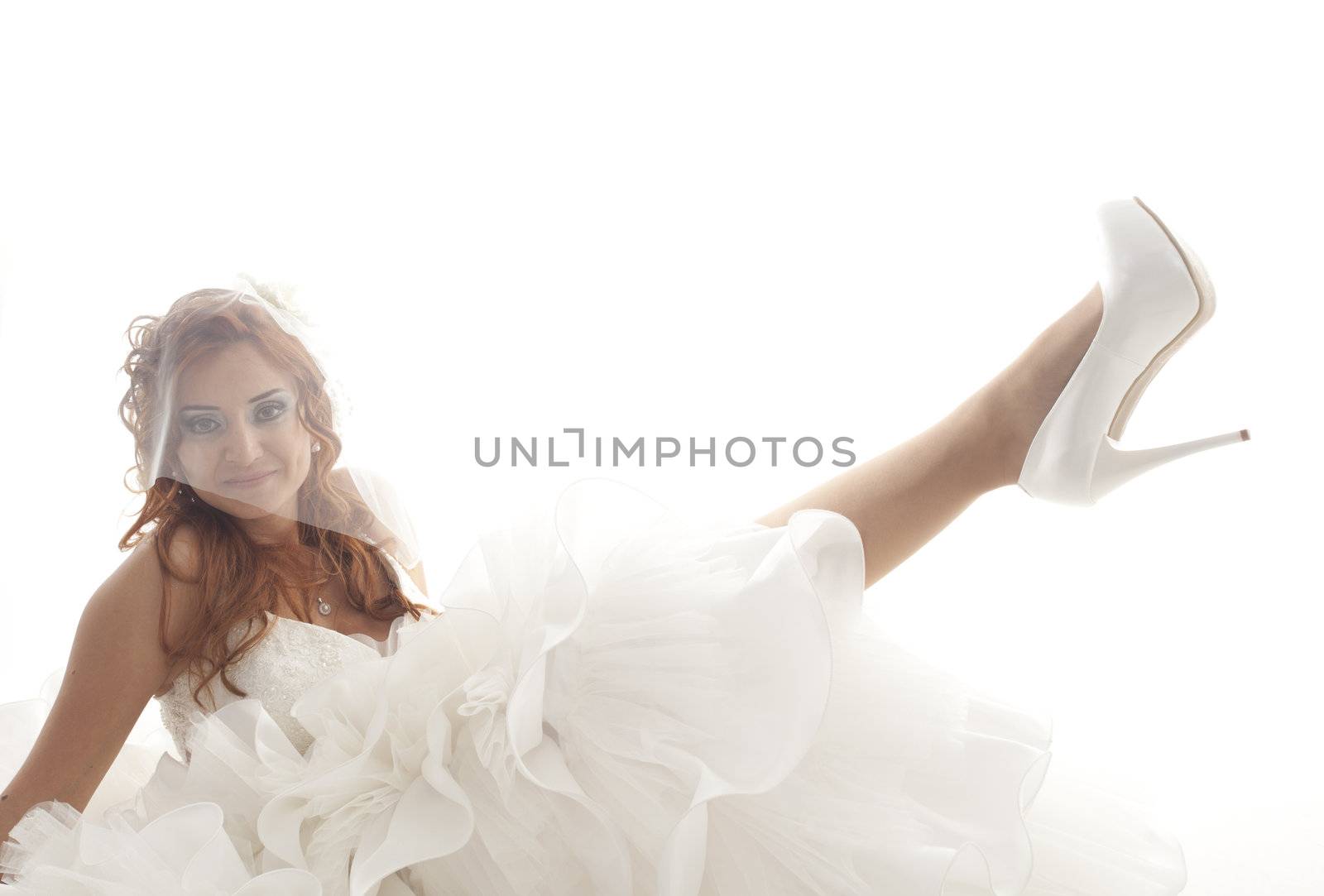 Portrait of young beautiful smiling bride over white background
