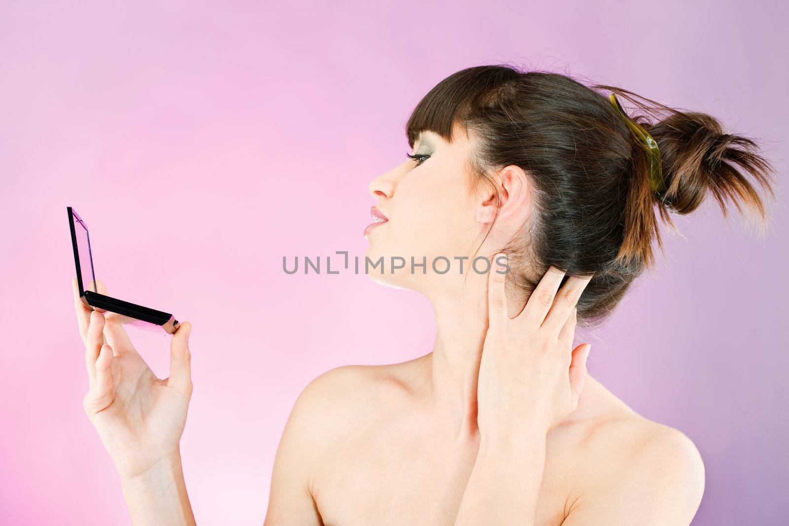 woman checking face skin in mirror by imarin