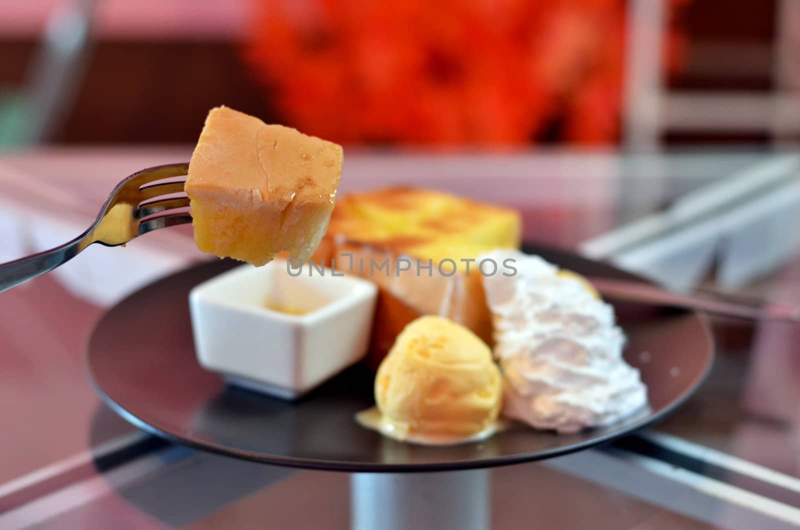 close up toast  on fork , toast and whipping cream with vanilla ice cream  served with honey sauce