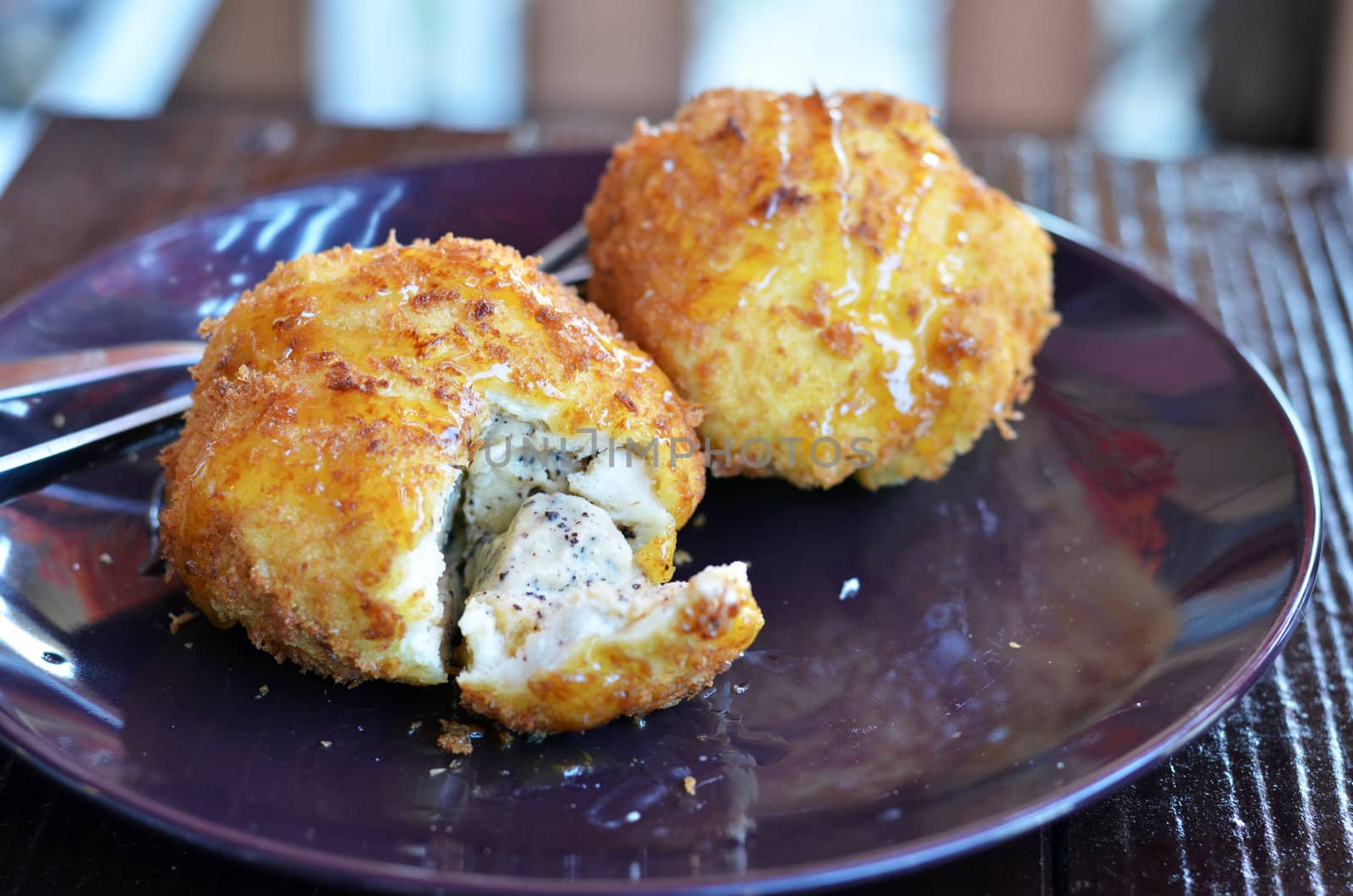 deep fried bread served with honey sauce , ice cream inside