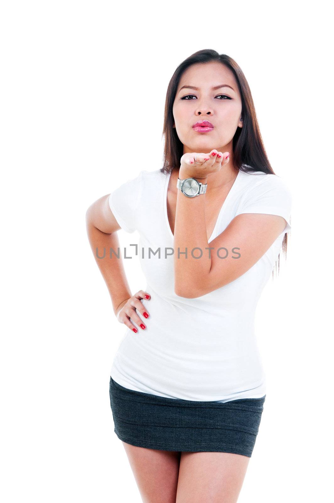Portrait of cute young woman blowing a kiss, isolated on white.