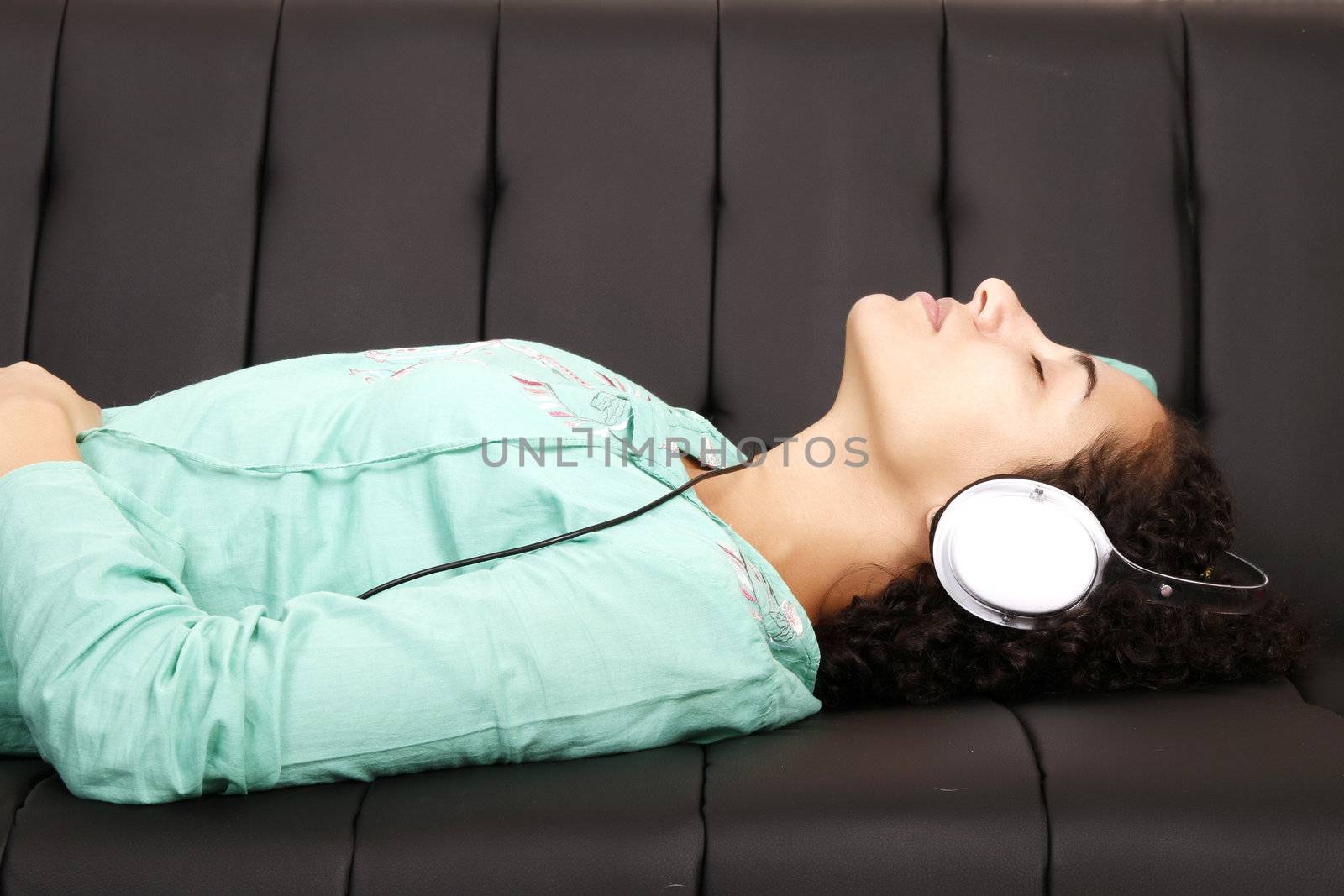 A jung brazilian woman relaxing on the sofa.
