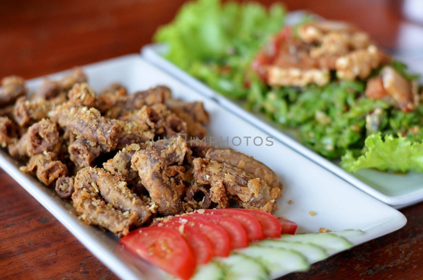 deep fried Pork's colon with garlic served with fresh vegetable