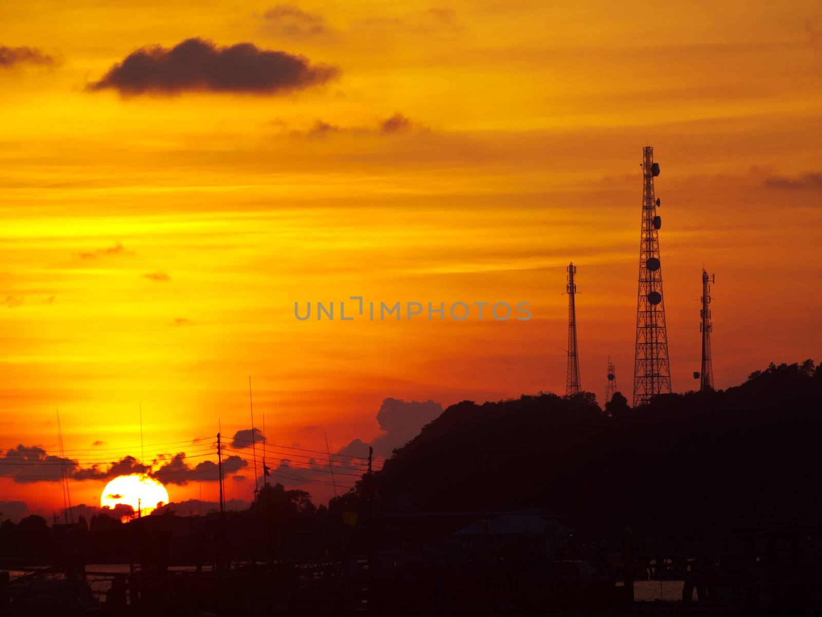 Golden sky with telecommunication tower on top of mountain