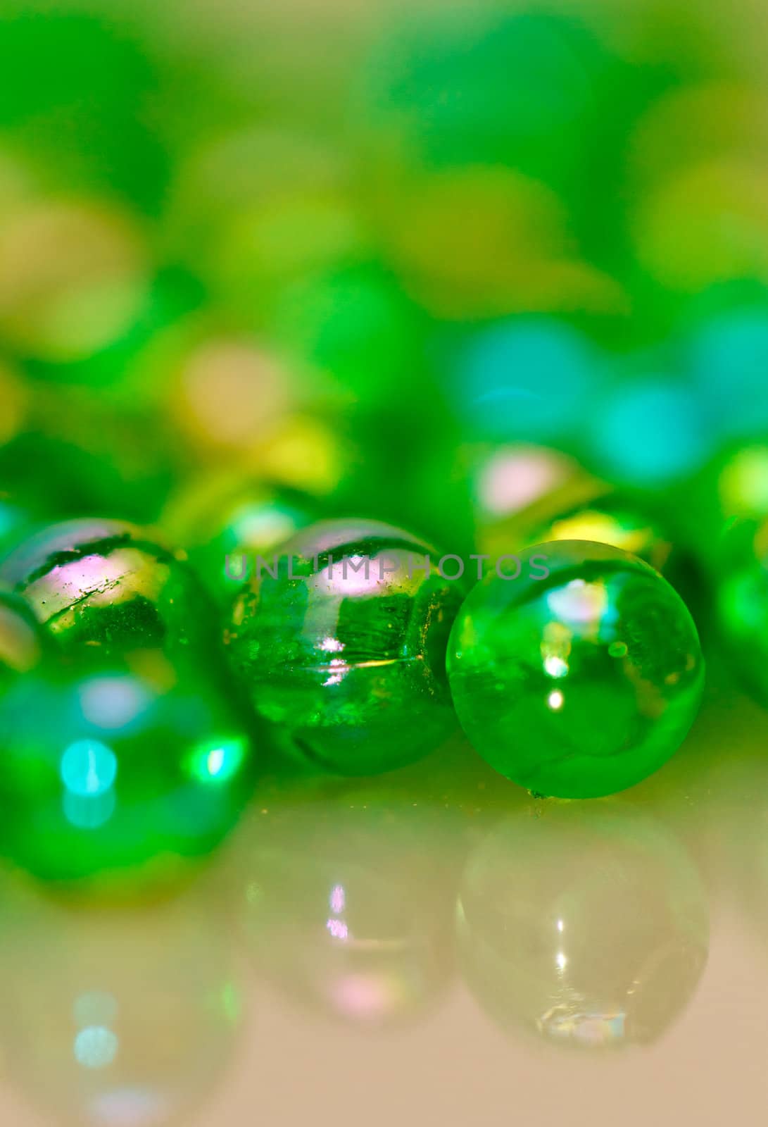 Green beads on the mirror with mirror image in portrait orientation