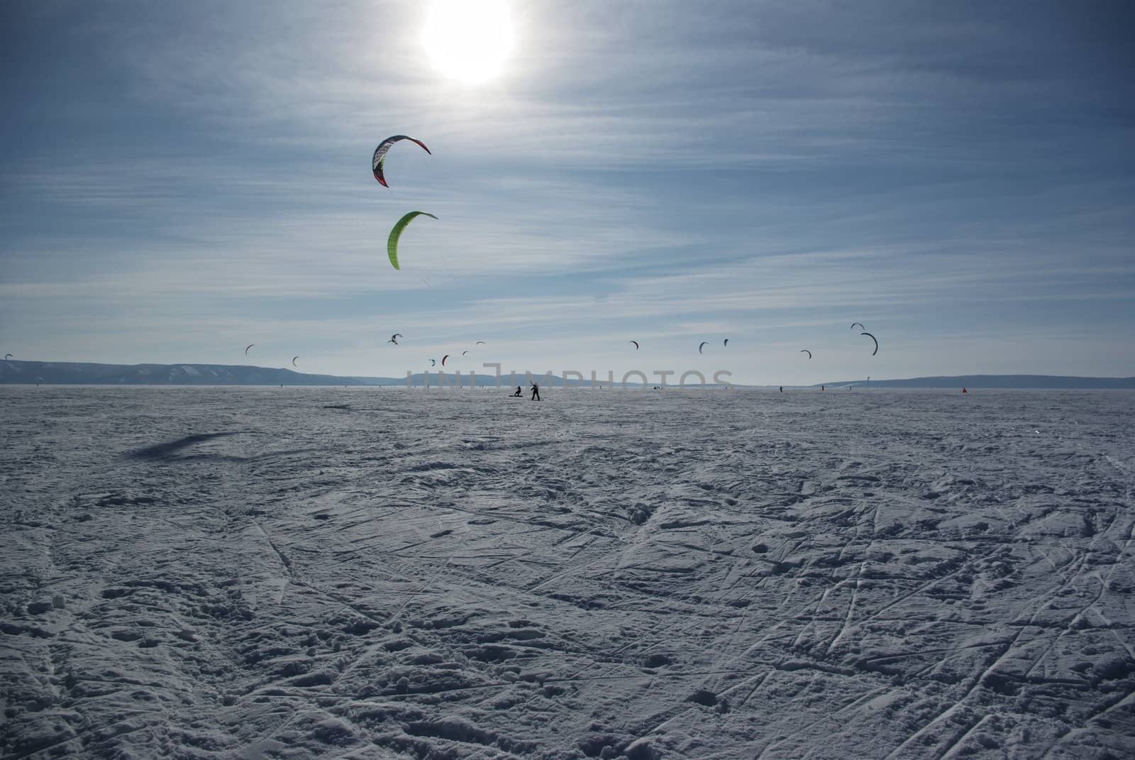 Winter kite skiing on the frozen river