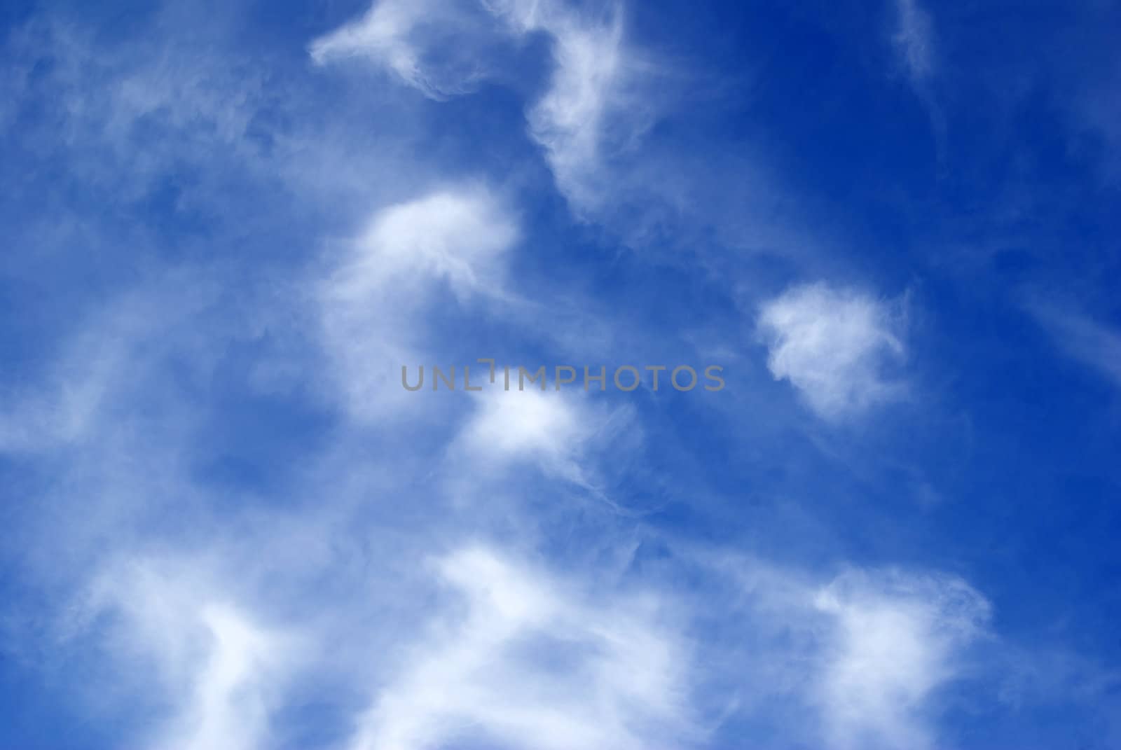 Blue sky background with tiny clouds