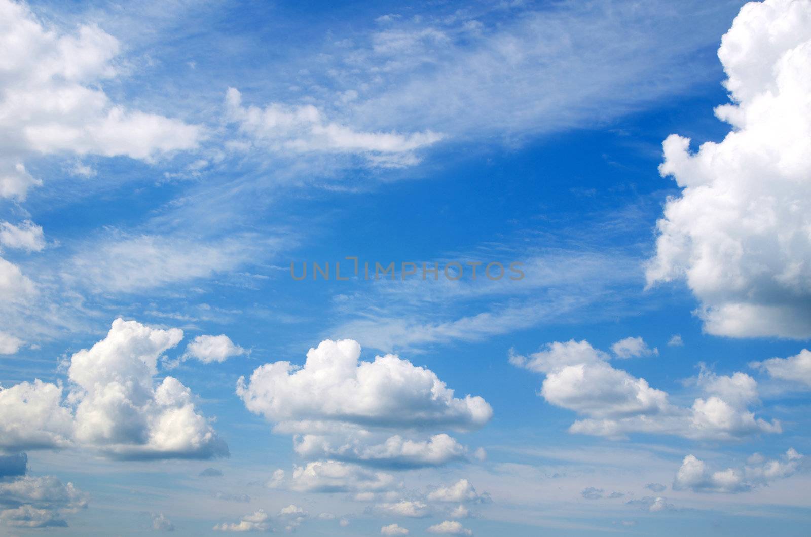 Blue sky background with tiny clouds