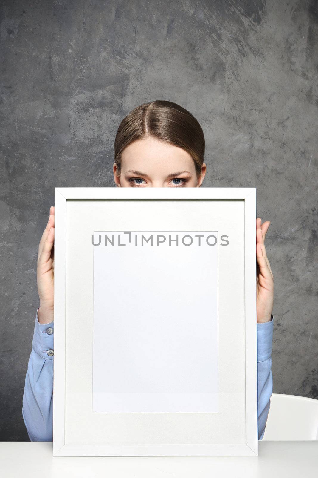 Young woman displaying a banner add isolated over a white background