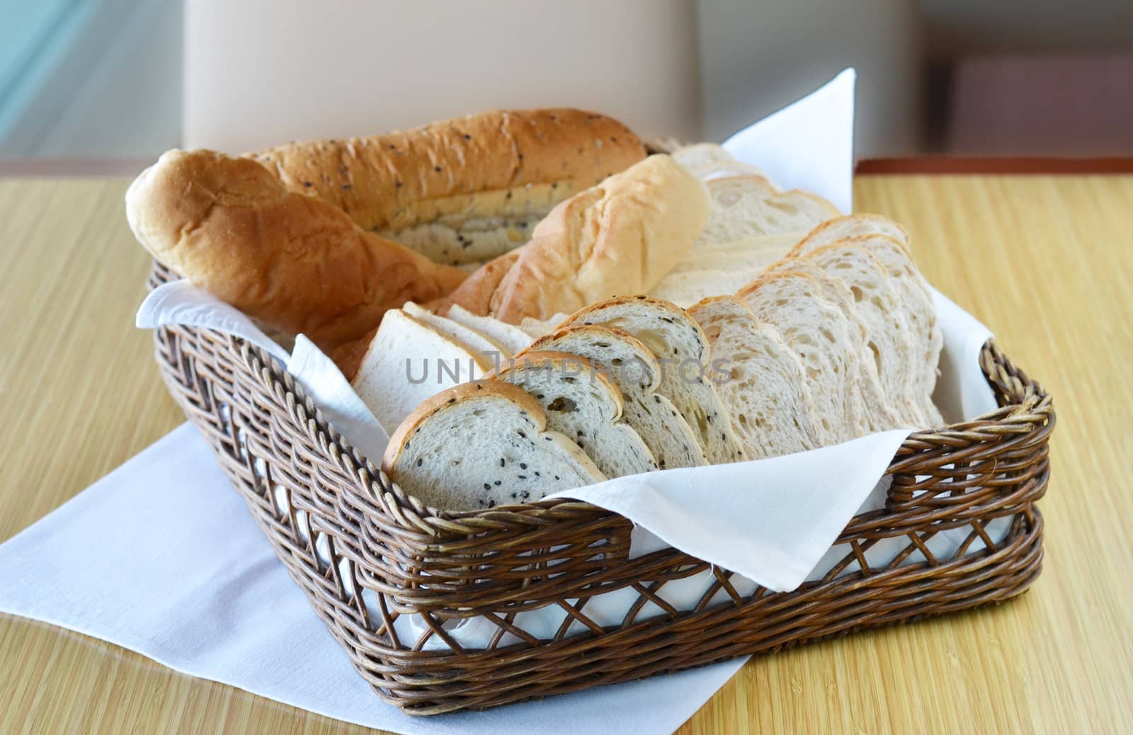 Arrangement of bread in basket on table