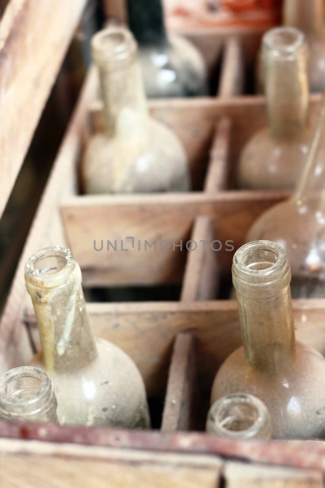 old empty wine bottles in a wooden box