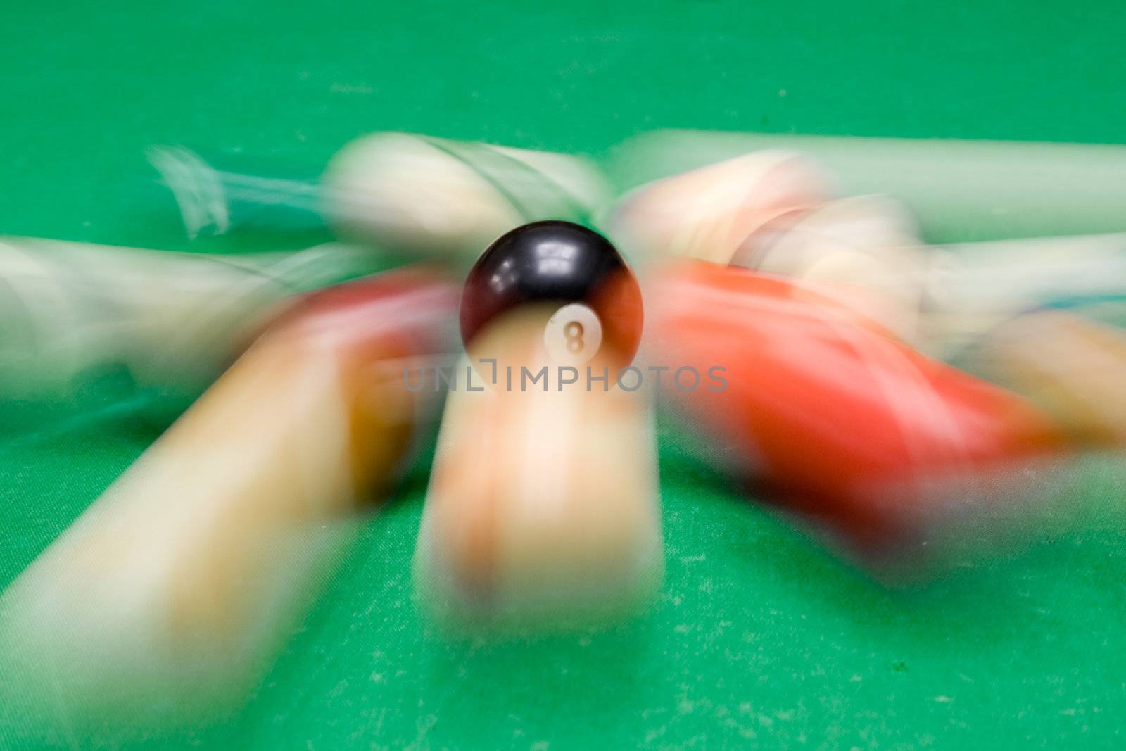 Several billiard balls in motion.