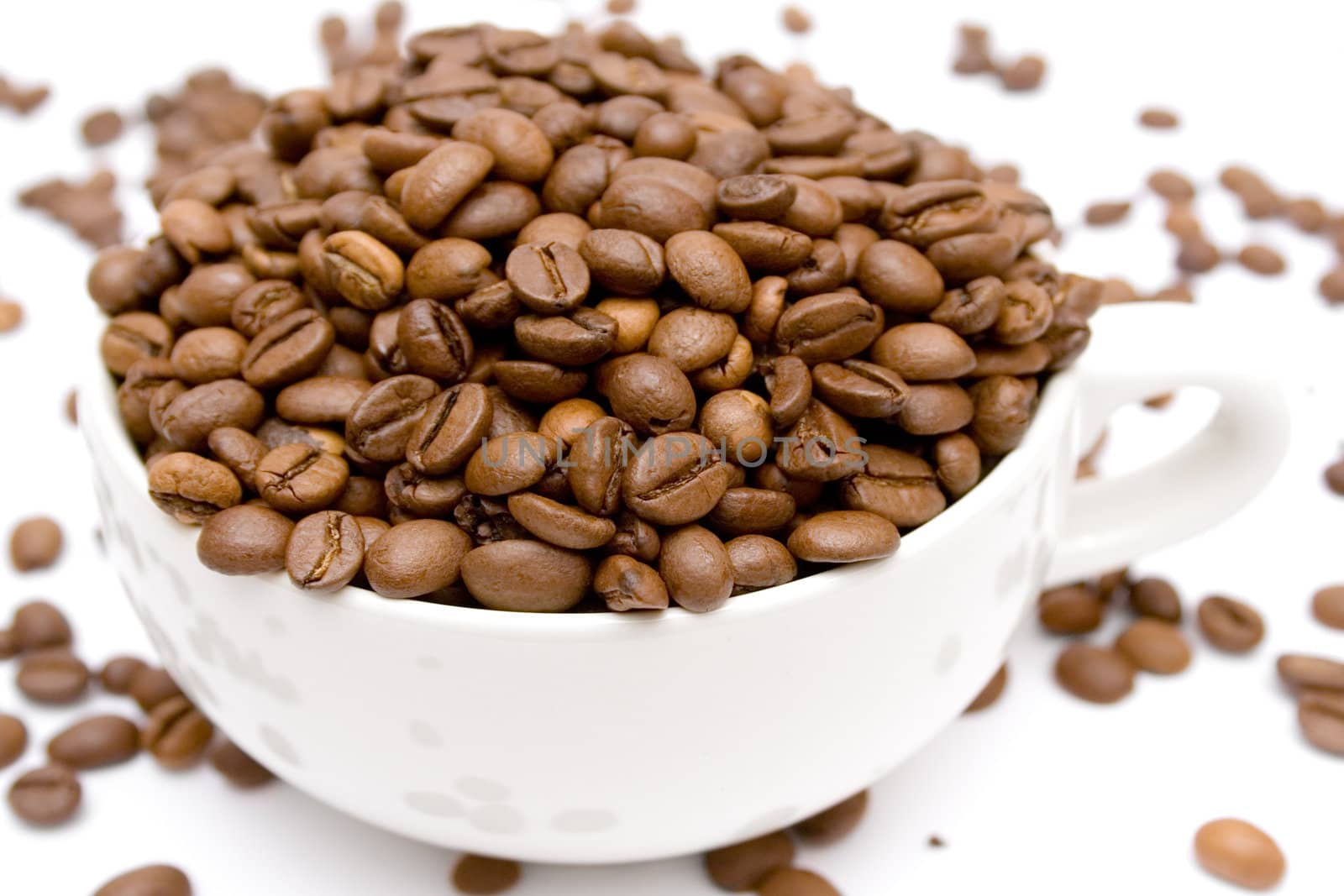 Coffe beans in a cup isolated on a white background.