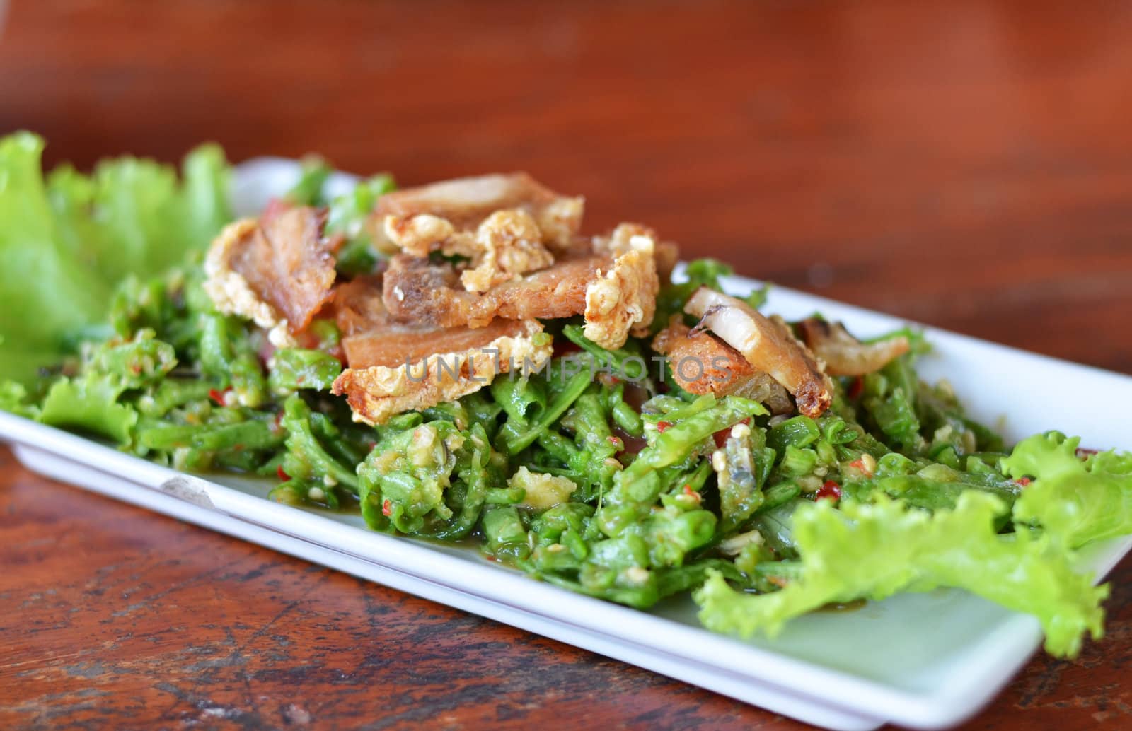 String bean spicy salad served with crispy pork