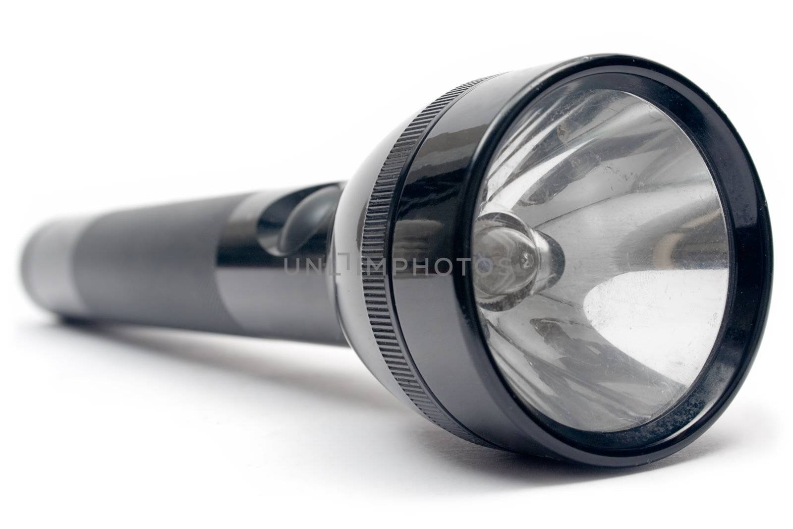 Metal coated flashlight isolated on white.