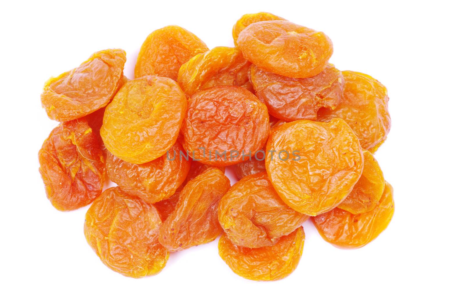 heap of dried apricots over white