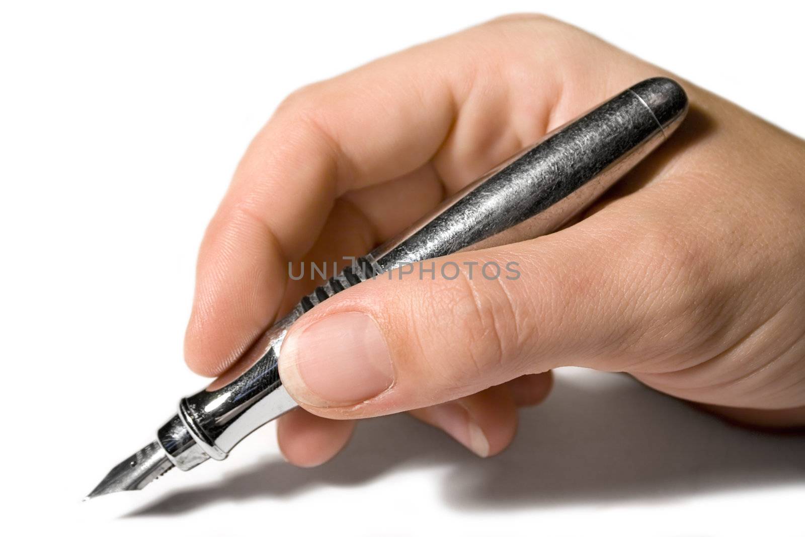 Female hand writing on white sheet of paper.