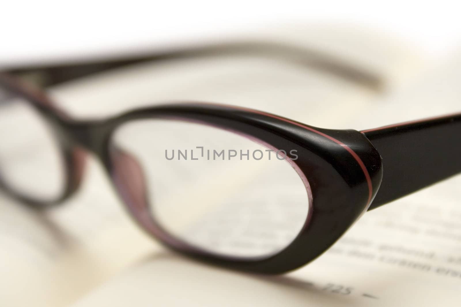 Glasses on an open book. Shallow depth of field.