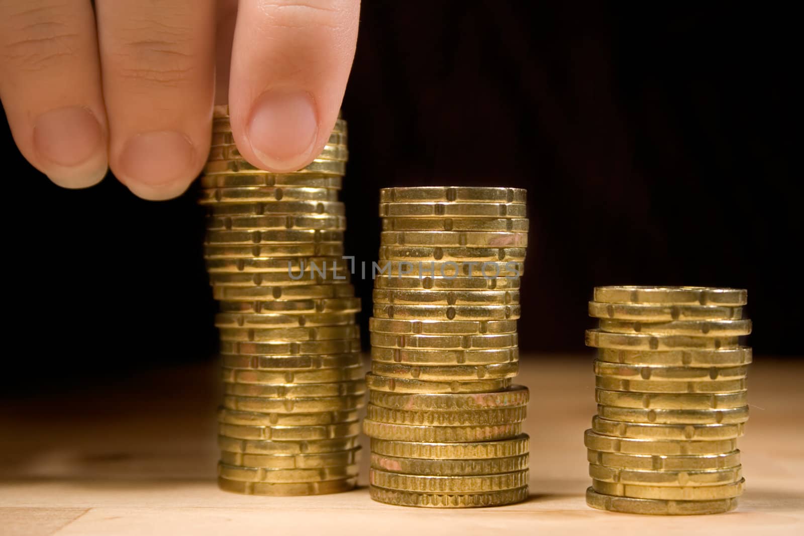 Stacking up 20 cent coins on a table.