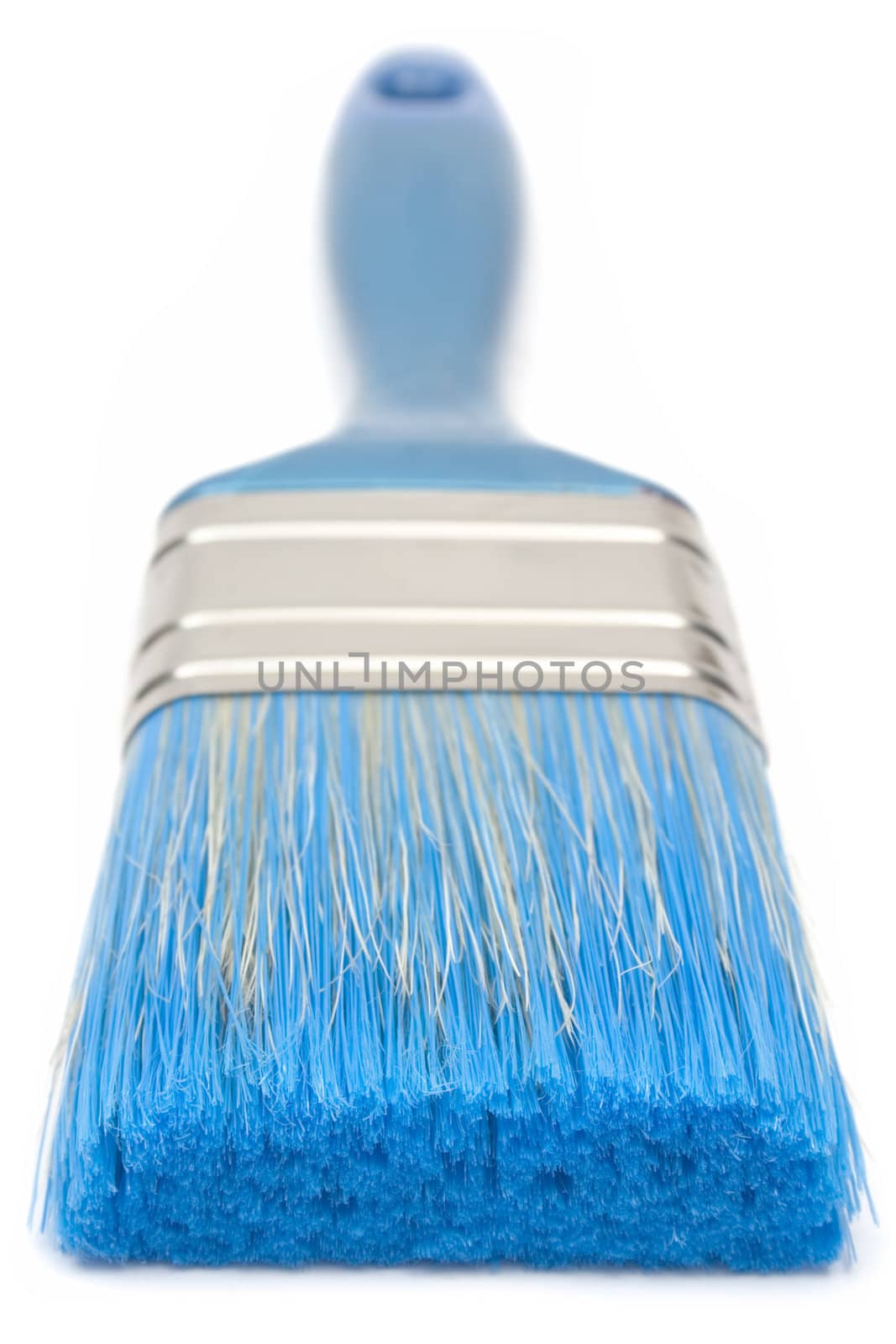 Detail view on a blue paint brush on white background. Shallow depth of field.
