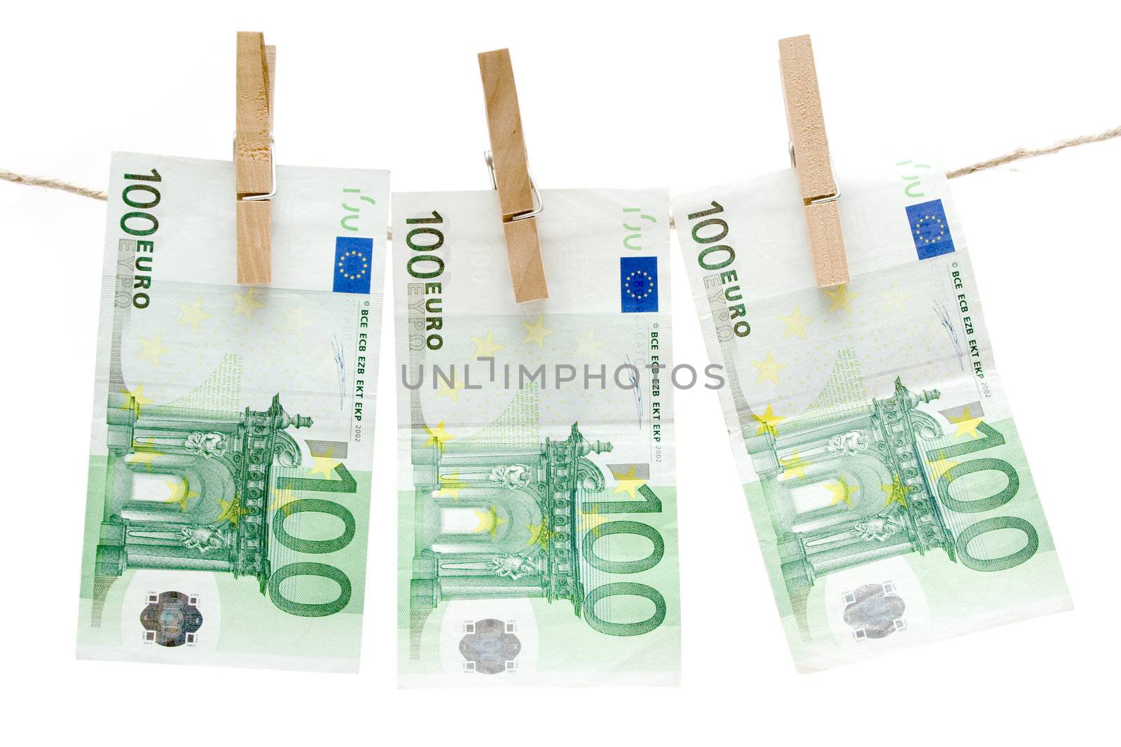 Three one hundred euro bills hanging on a clothesline. Isolated on a white background.