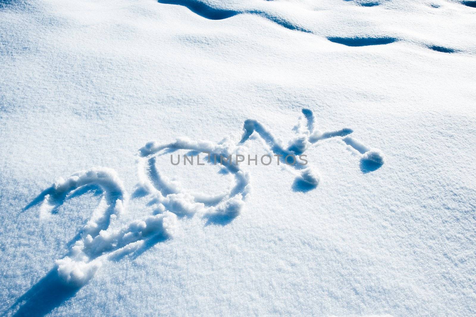 Year 2014 written in a snow landscape