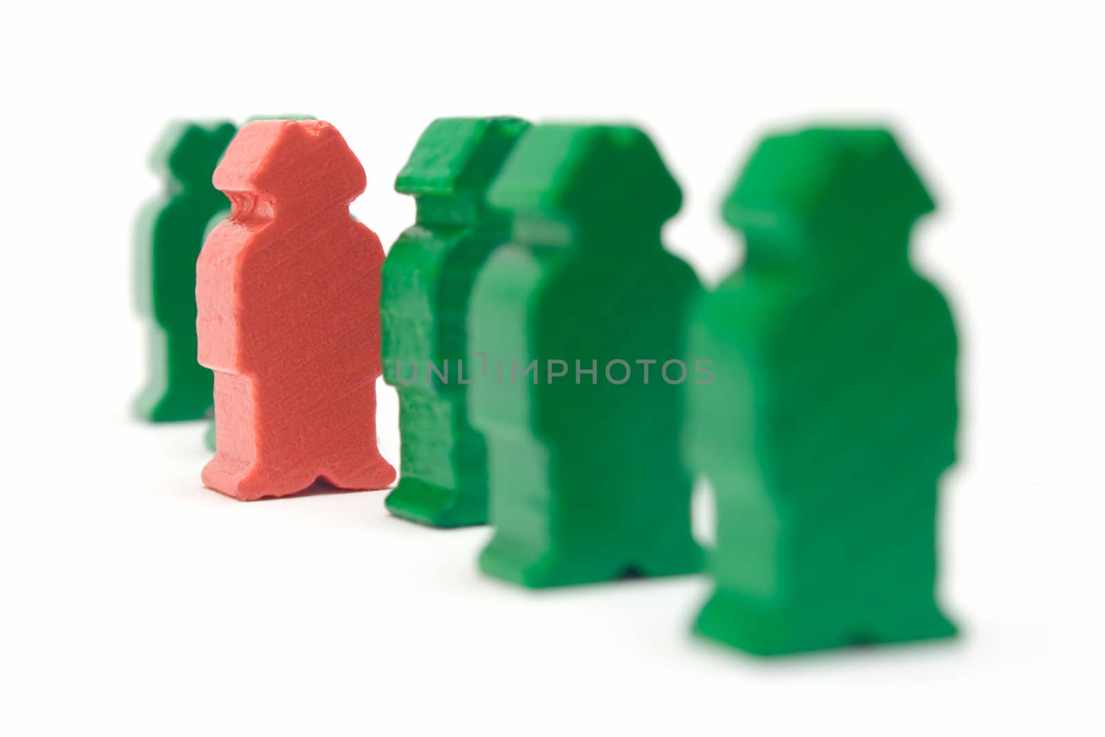 Standing out of the crowd. Shallow depth of field. Focus on the red figure.